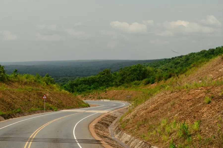 A winding road through green hills in Uganda