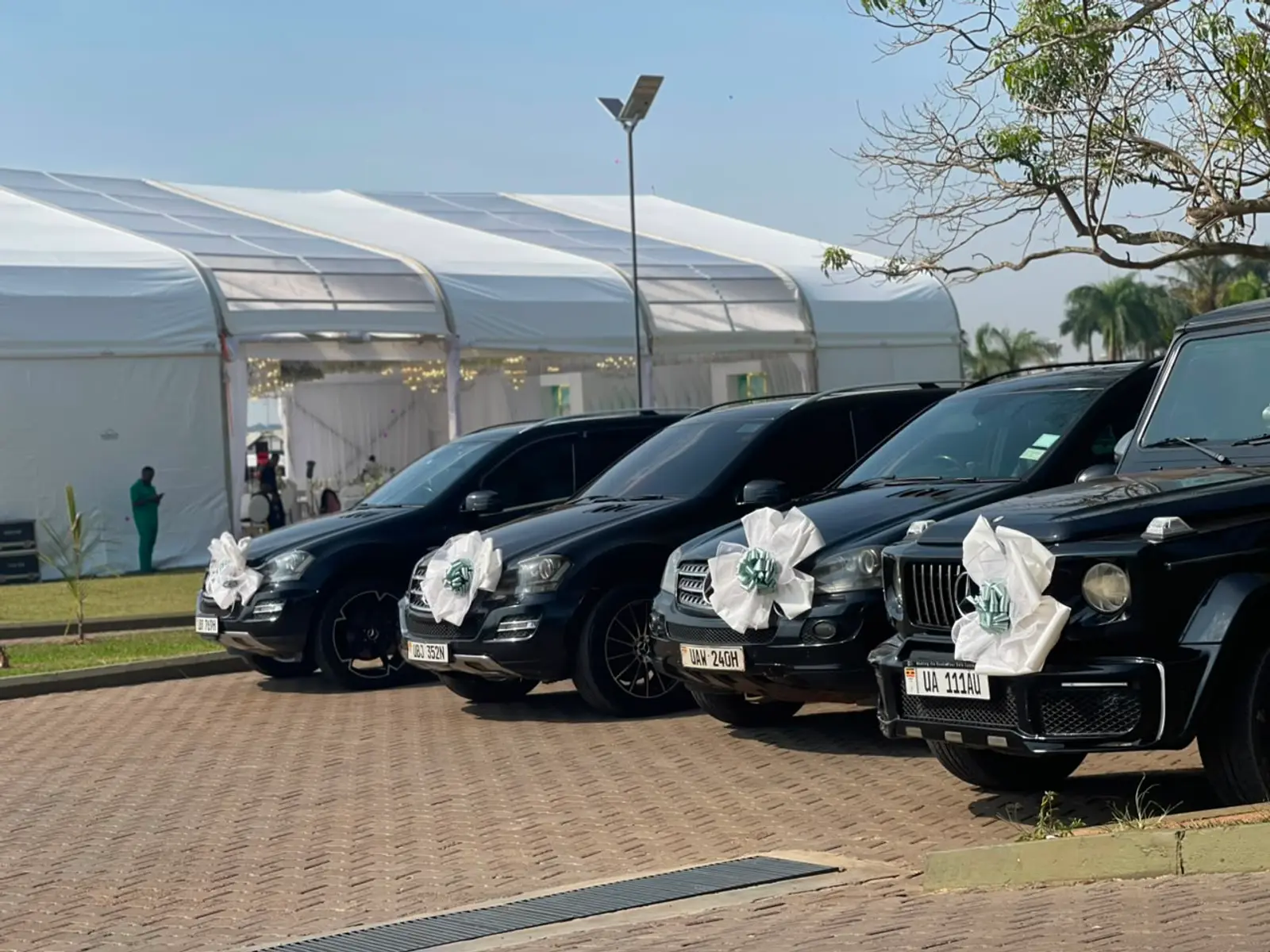 Black Right Rides cars with white wedding ribbons outside a wedding reception